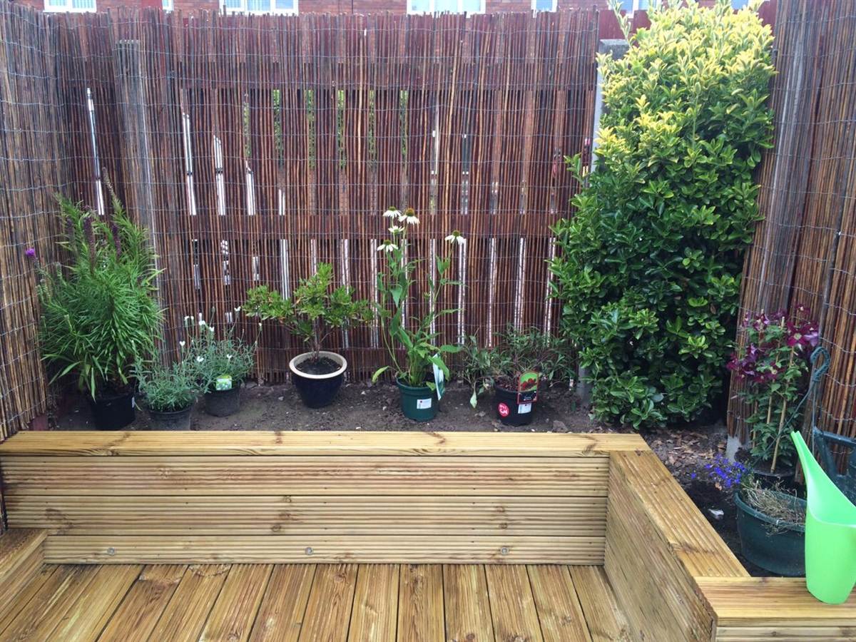 After — raised planter beds planted up along the back