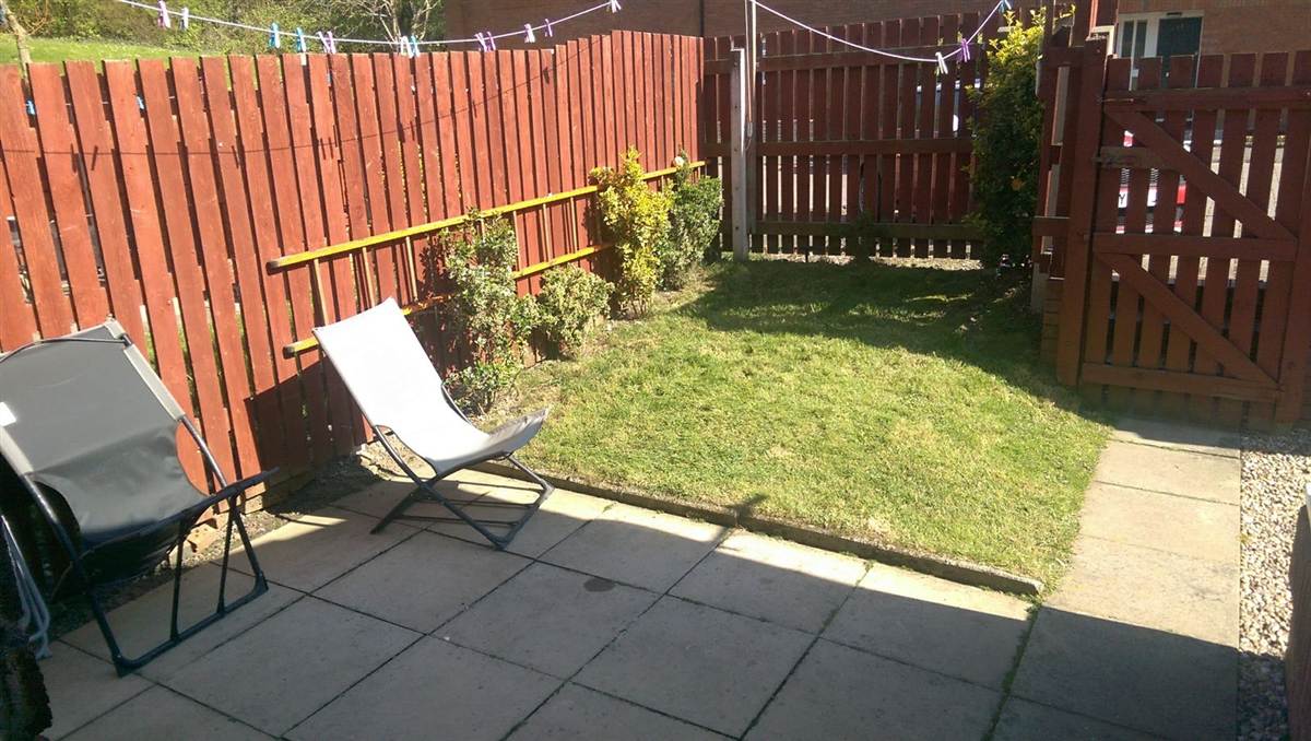Before — original garden with patio and lawn, no decking