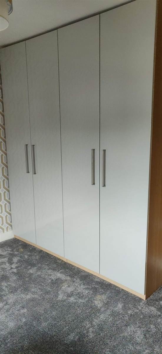 IKEA flat-pack wardrobes built, handles fitted and positioned in room