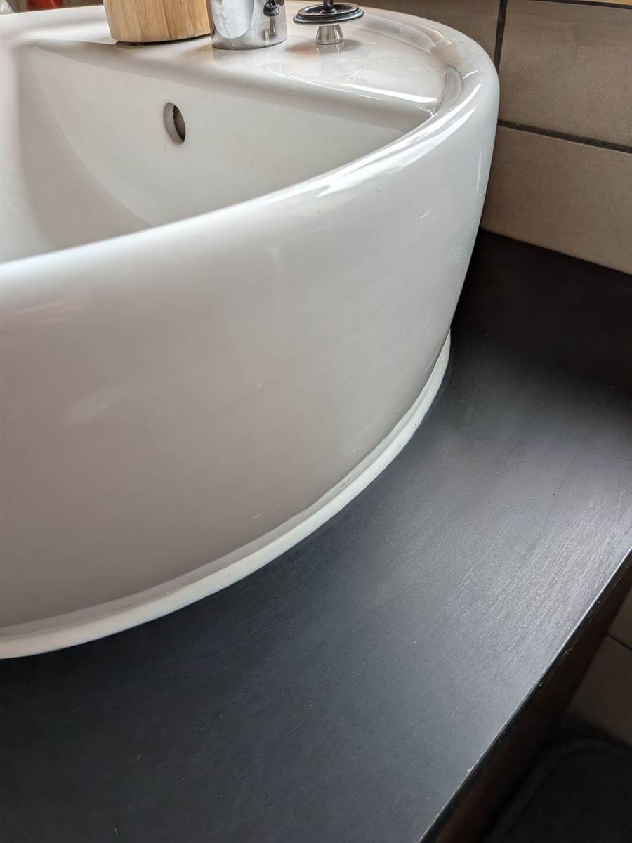 Sink resealed neatly — clean silicone bead, no gaps