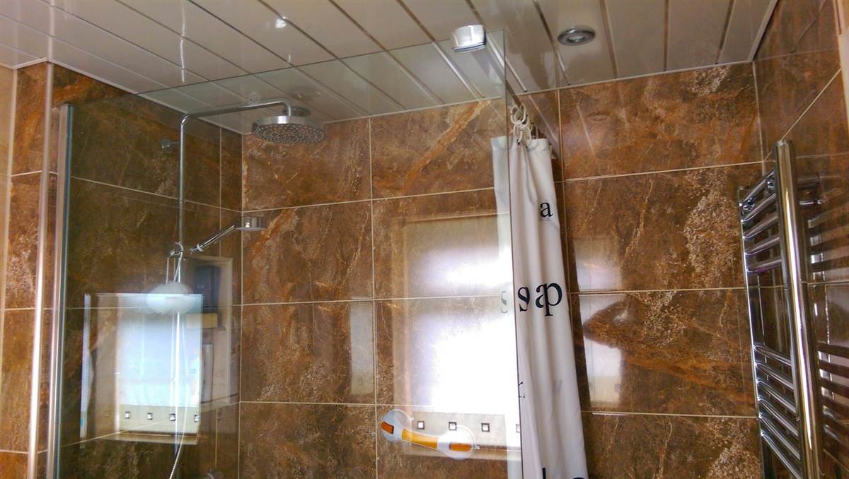 Finished walk-in shower with rain head, riser rail and thermostatic mixer valve