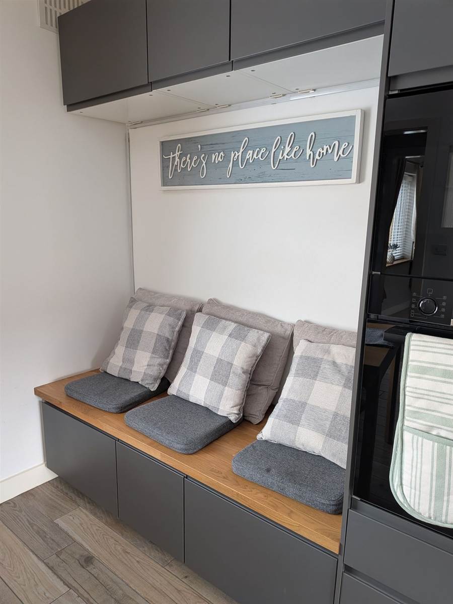 After — built-in bench seating with oak worktop and grey storage units underneath, wall cabinets above