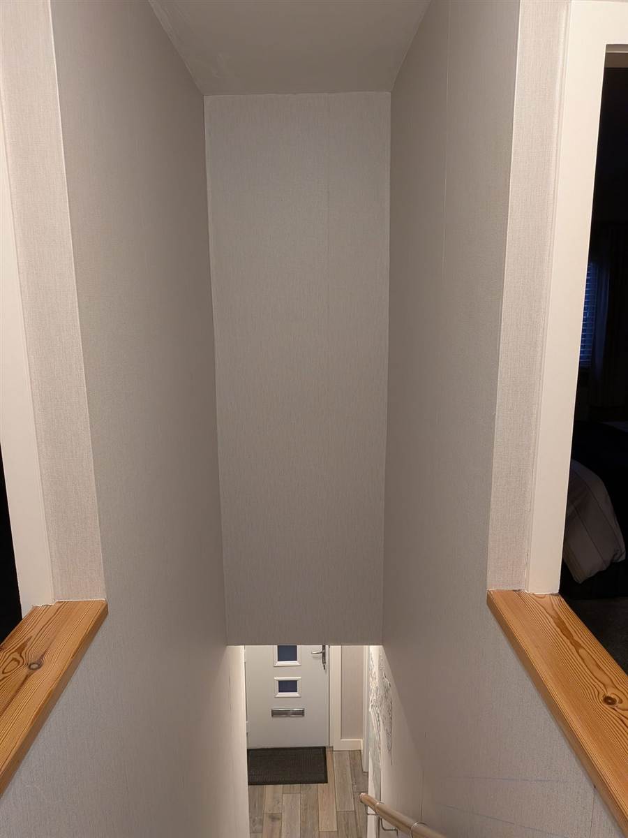 Before — plain painted stairwell wall, the starting point