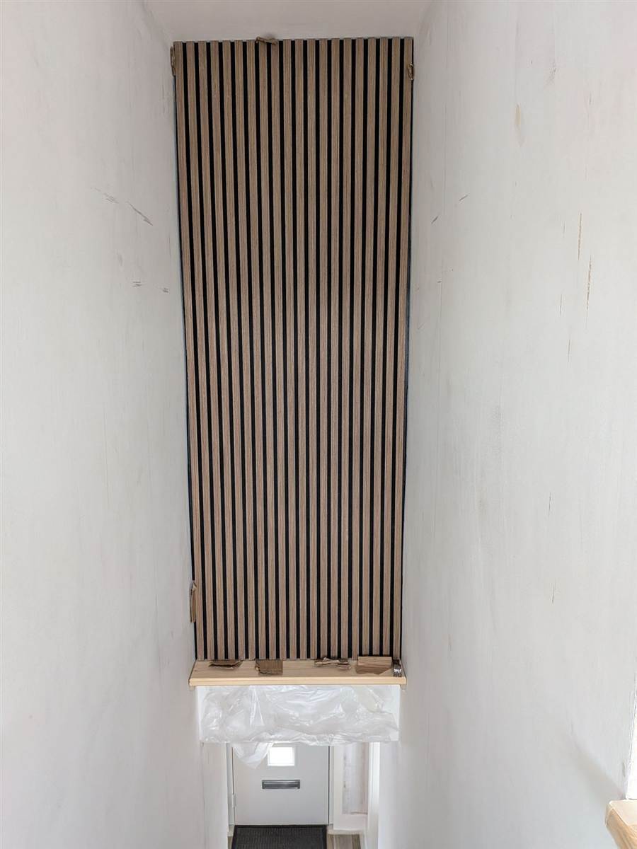 During — oak slat panel going up in the stairwell